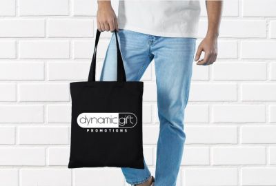 A man carrying his custom branded tote, promoting marketing merchandise at a trade show in Toronto.