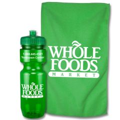 A translucent green 22oz bike bottle with a white logo beside a green towel with a white logo 