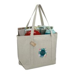 A custom logo boat tote made from recycled cotton. It is filled with beach accessories and the front has a full colour print.