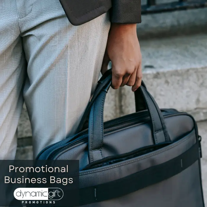 A person carries their branded business bag given as a custom corporate gift.