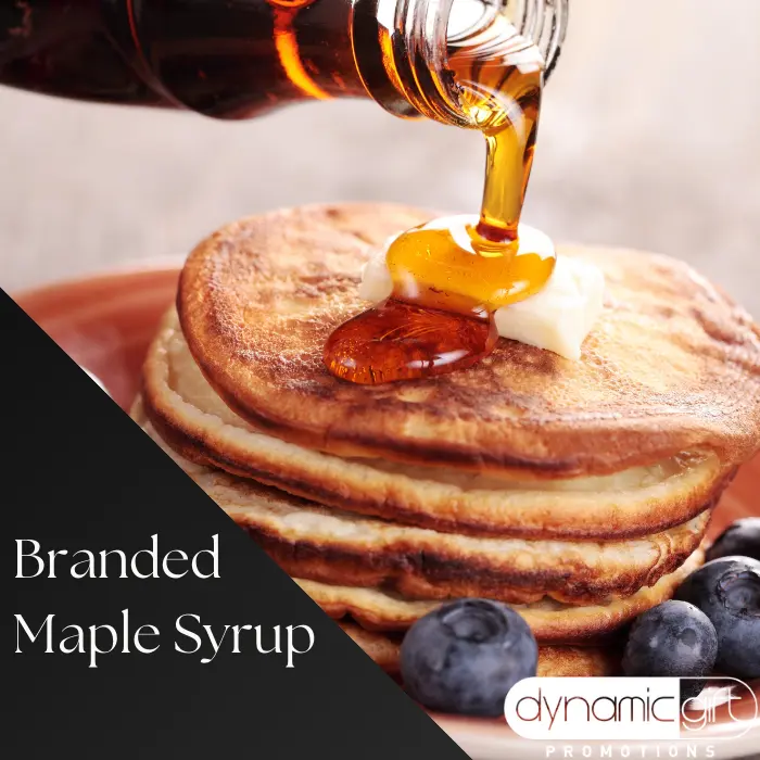 A stack of fluffy pancakes with maple syrup being poured on them.