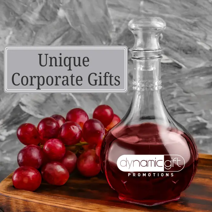 A custom logo wine carafe with Dynamic Gift's logo beside some Ontario-grown wine grapes.