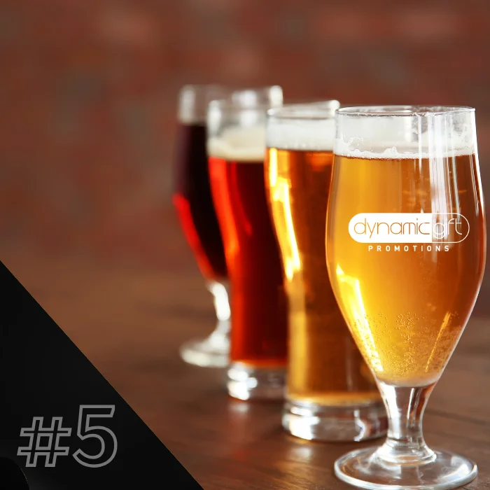 Various custom logo beer glasses lined up in an Ontario pub.