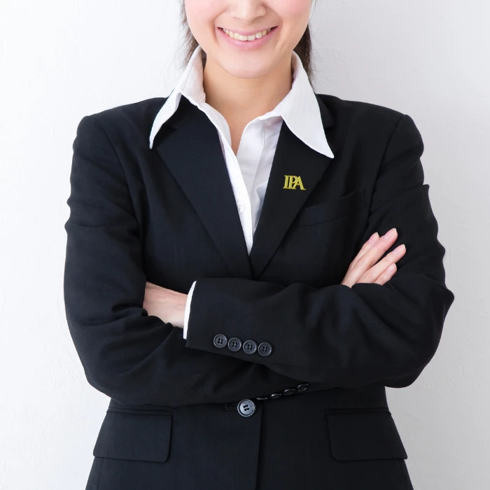 A woman wearing a custom lapel pin attached to her suit.