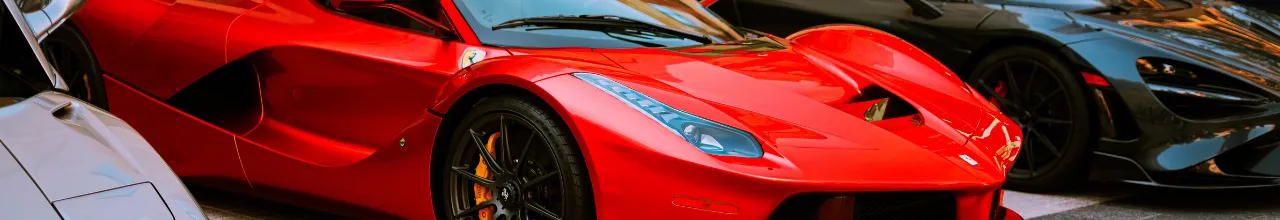 Three sports cars on display at a car show in downtown Toronto.