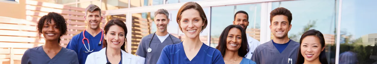 Healthcare workers waiting for their promotional essentials smile at the camera outside a building in Mississauga.